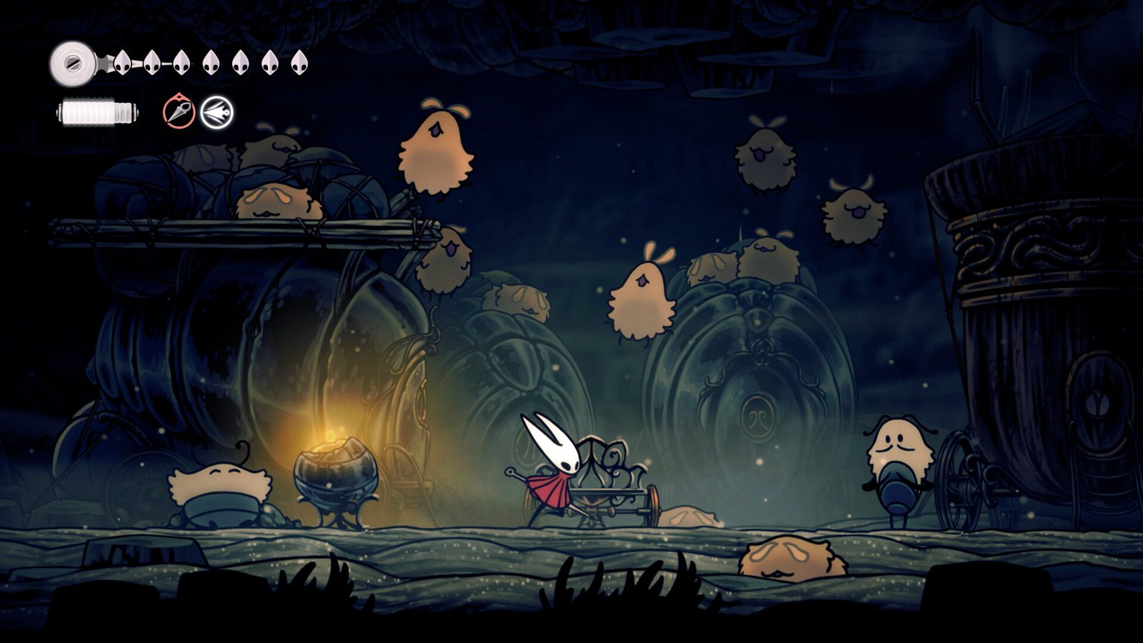 Hornet cạnh một chiếc ghế nghỉ giữa những sinh vật lông xù bay lơ lửng trong hang tối ở Hollow Knight: Silksong