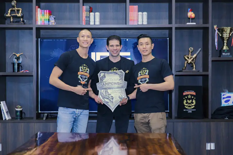 TK Nguyen with Randy Dobson and Dru Nguyen beside a GAM championship trophy.